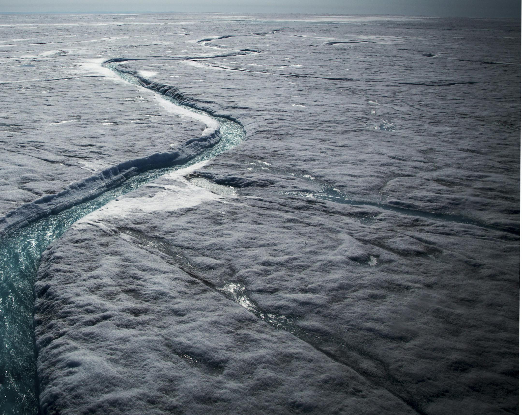 FILE-- Meltwater flows along a supraglacial river on the Greenland ice sheet, one of the biggest and fastest-melting chunks of ice on Earth, on July 19, 2015. Scientists reported Jan. 18, 2017, that the Earth reached its highest temperature on record in 2016. It is the first time in the modern era of global warming data that temperatures have blown past the previous record three years in a row. The heat extremes were especially pervasive in the Arctic. (Josh Haner/The New York Times) ORG XMIT: X