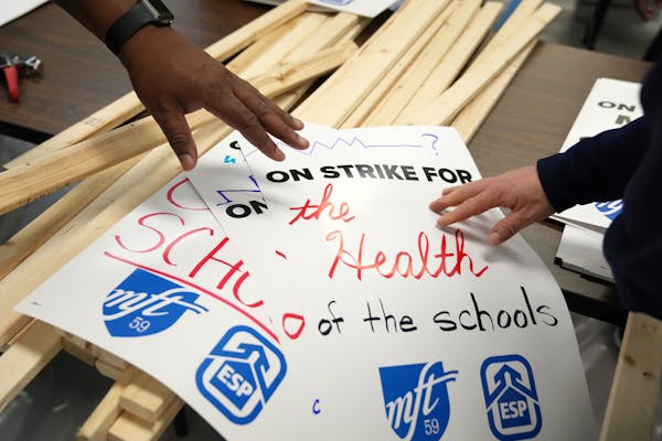 Union members and supporters created picket signs at the Minneapolis Federation of Teachers and Education Support Professionals offices in northeast M