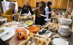 Women serves themselves with real plates and utensils during the potluck Iftar dinner at Club ICM. ] LEILA NAVIDI &#xa5; leila.navidi@startribune.com 