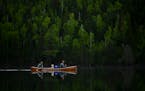 Tony Jones, his dog Crosby, and Star Tribune Outdoors editor Bob Timmons paddled from Mountain Lake toward their portages to Moose Lake in the Boundar