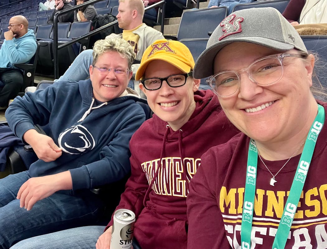 Jillian Hiscock, right, is going from women’s sports fan to women’s sports bar owner. Here she’s at the Big Ten women’s basketball tournament last year with her wife, Megan Slater, center, and Kathy Moore, left.