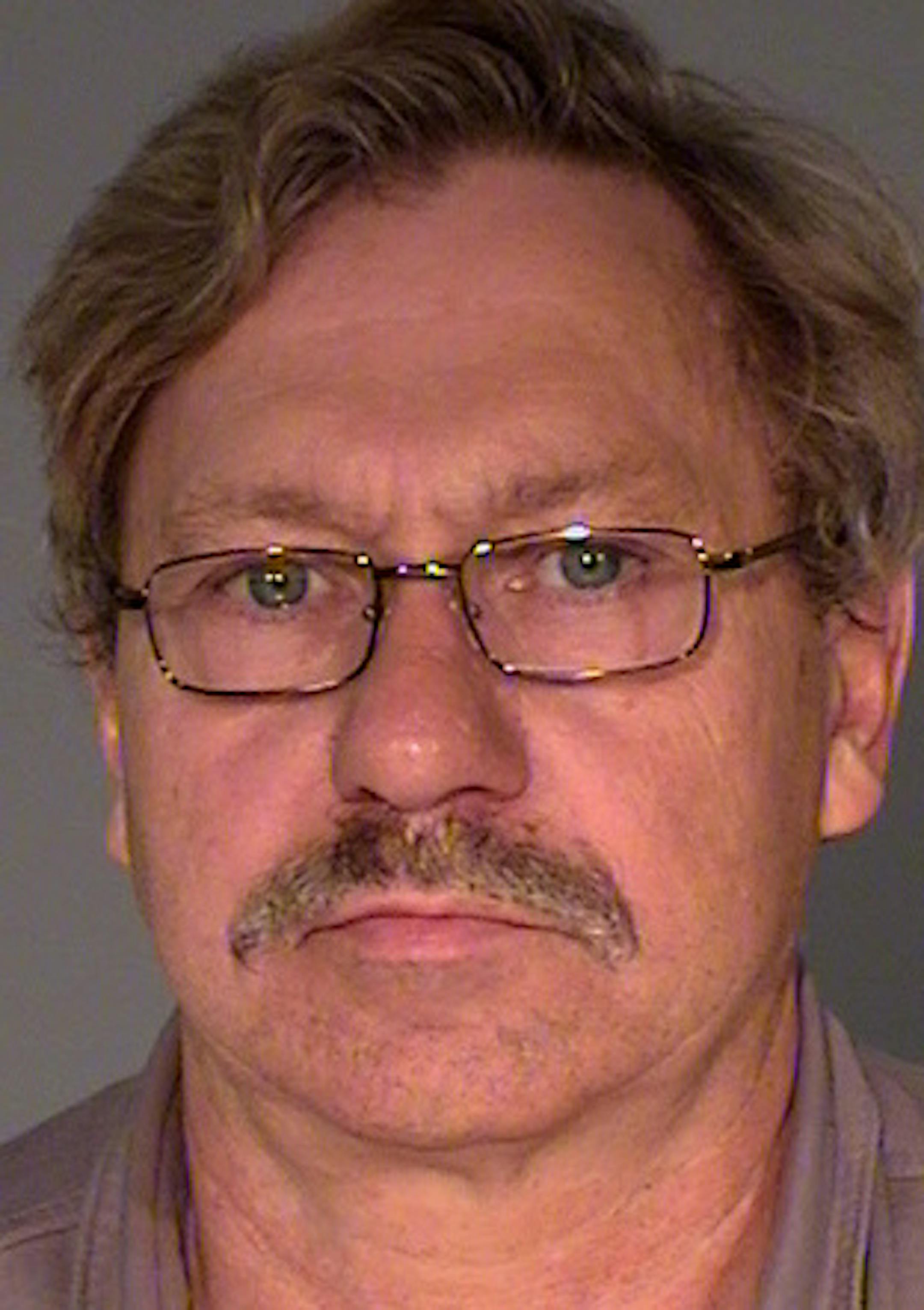 Walter J. Happel, 63, is charged with peeking underneath a bathroom stall at a student in St. Paul.