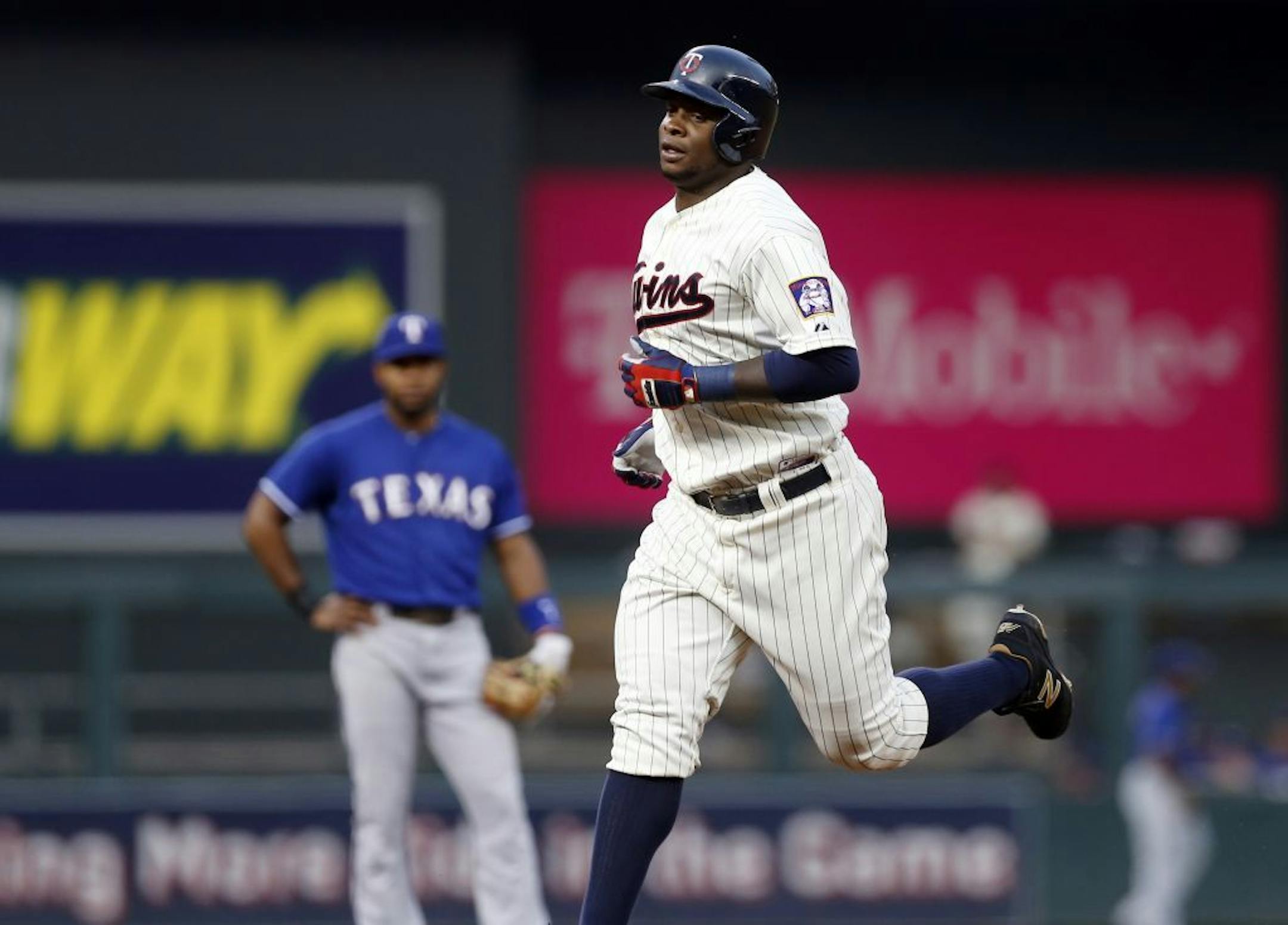 Minnesota Twins� Miguel Sano rounds the bases on a two-run home run off Texas Rangers pitcher Nick Martinez during the third inning of a baseball game, Wednesday, Aug. 12, 2015, in Minneapolis.