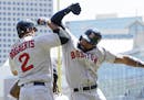 Boston Red Sox's Jackie Bradley Jr., right, celebrates with Xander Bogaerts after Bradley's three-run home run off Minnesota Twins pitcher Kyle Gibson