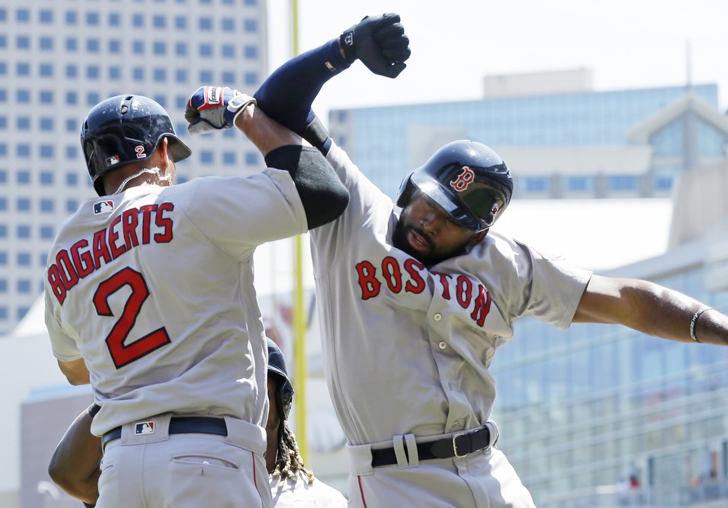 Boston Red Sox's Jackie Bradley Jr., right, celebrates with Xander Bogaerts after Bradley's three-run home run off Minnesota Twins pitcher Kyle Gibson in the first inning of a baseball game Saturday, June 11, 2016, in Minneapolis. (AP Photo/Jim Mone) ORG XMIT: MNJM108