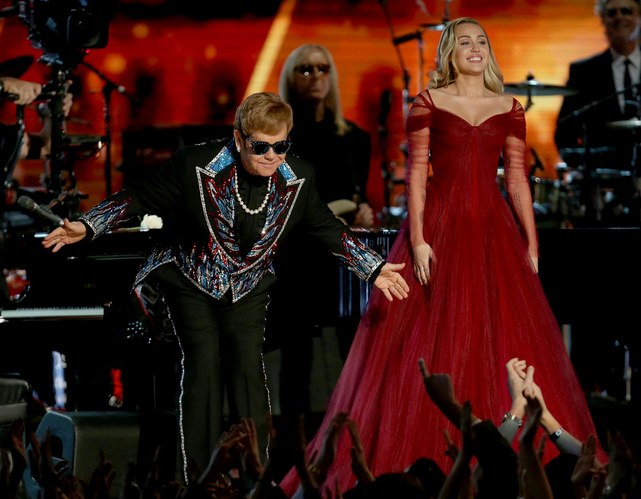 Elton John, left, and Miley Cyrus appear after a performance of "Tiny Dancer" at the 60th annual Grammy Awards at Madison Square Garden on Sunday, Jan. 28, 2018, in New York.