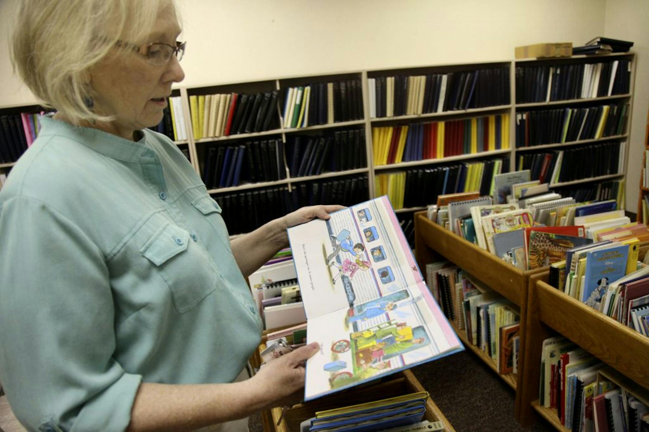 Dorothy Worthington showed how Volunteer Braille Services of Golden Valley places Braille raised-dot coding on books so that blind readers can read them.