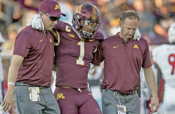 Minnesota's running back Rodney Smith is helped off the field after a first quarter injury as Minnesota took on Fresno State at TCF Bank Stadium, Satu