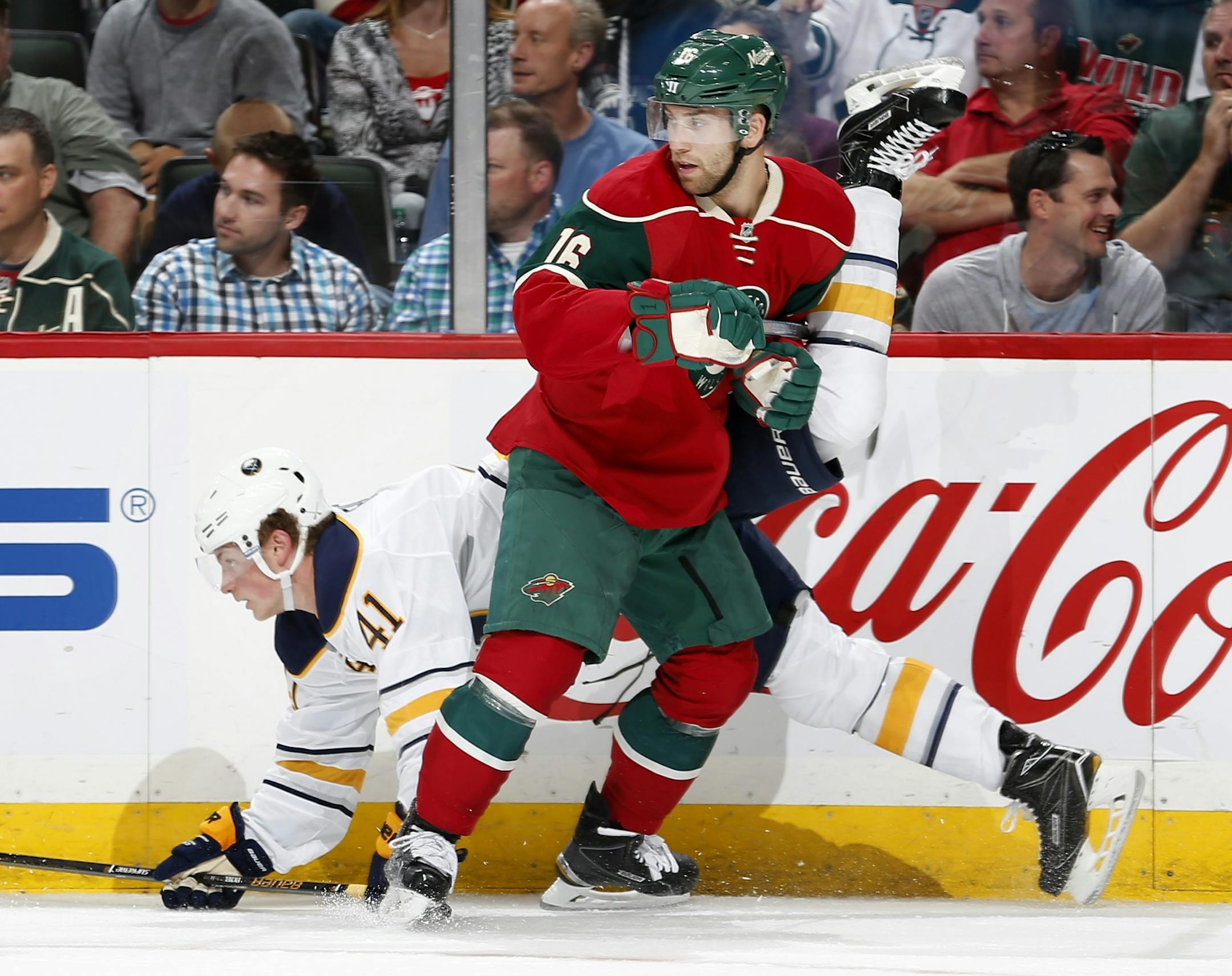 Jack Eichel (41) of the Buffalo Sabres tangled up with Jason Zucker of the Wild.