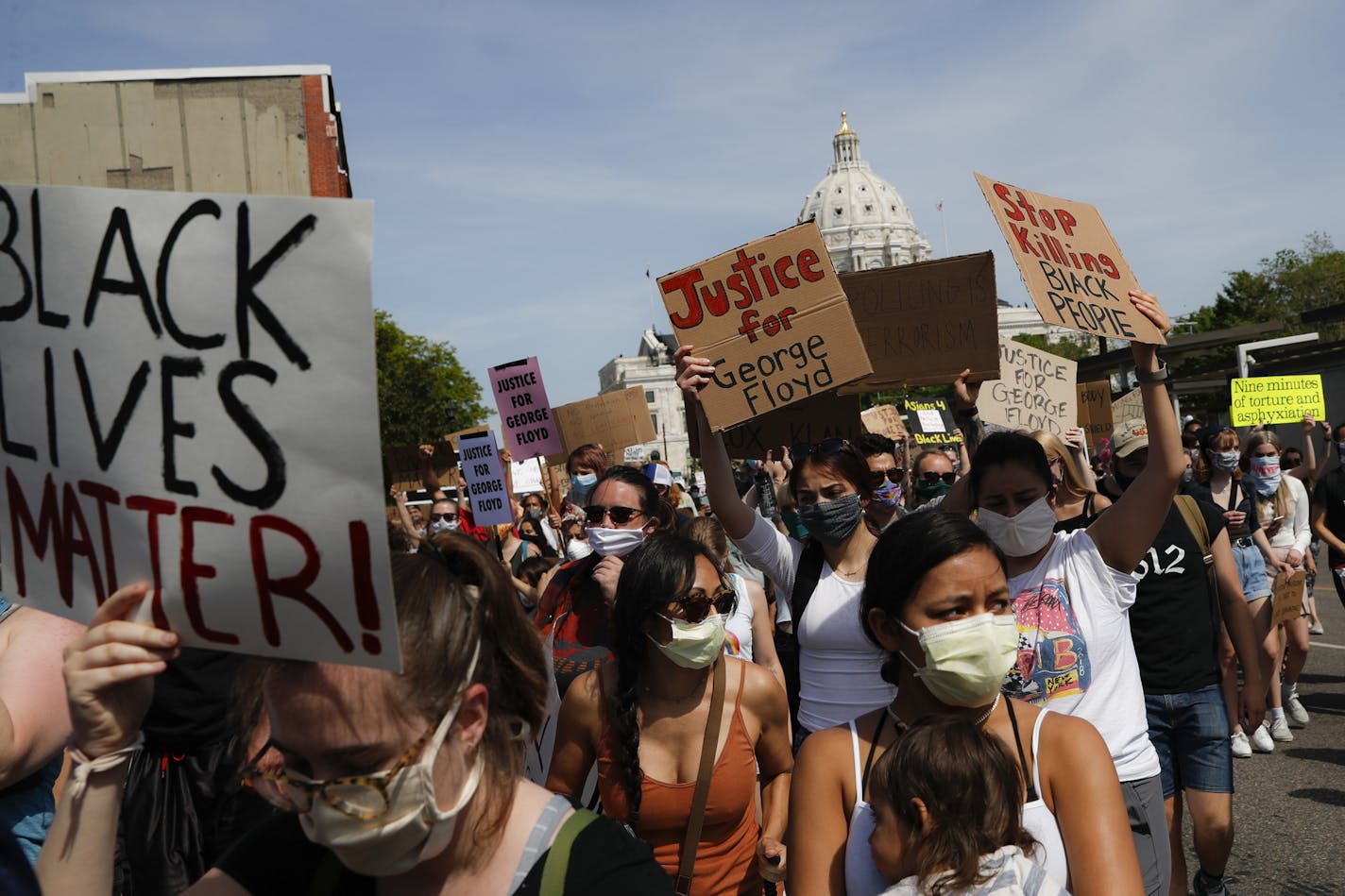 FILE - In this May 31, 2020, file photo, protesters march away from the State Capitol, in St. Paul, Minn. A loose network of Facebook groups that took root across the country in April to organize protests over coronavirus stay-at-home orders has become a hub of misinformation and conspiracies theories that have pivoted to a variety of new targets. Their latest: Black Lives Matter and the nationwide protests against racial injustice. (AP Photo/John Minchillo, File)