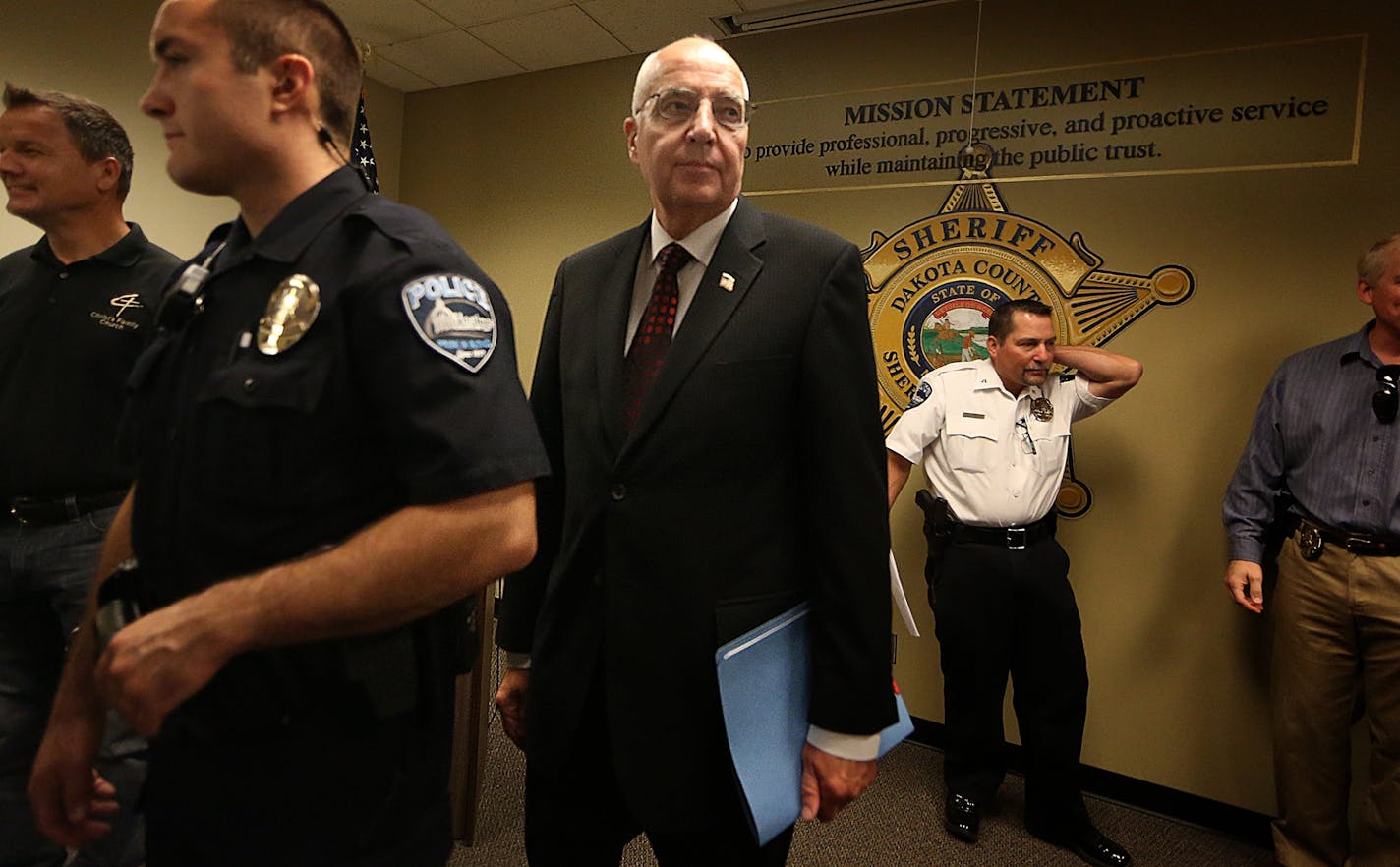 Dakota County Attorney James Backstrom (third from left) held a press conference Tuesday to talk about criminal charges related to Operation Guardian Angel, an undercover anti-sex trafficking effort.