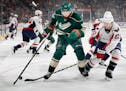 The Wild's Martin Hanzal (19) and Washington's Kevin Shattenkirk (22) fought for the puck in the first period Tuesday. ] CARLOS GONZALEZ � cgonzalez
