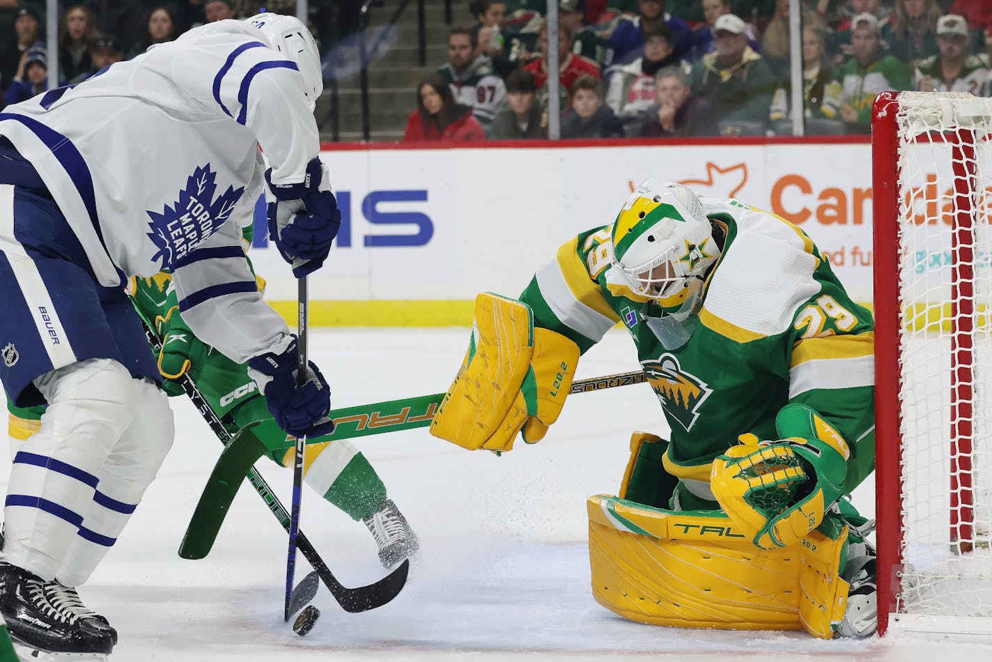 Toronto Maple Leafs center David Kampf (64) tries to score a goal against Minnesota Wild goaltender Marc-Andre Fleury (29) during the second period of an NHL hockey game Friday, Nov. 25, 2022, in St. Paul, Minn. (AP Photo/Stacy Bengs)