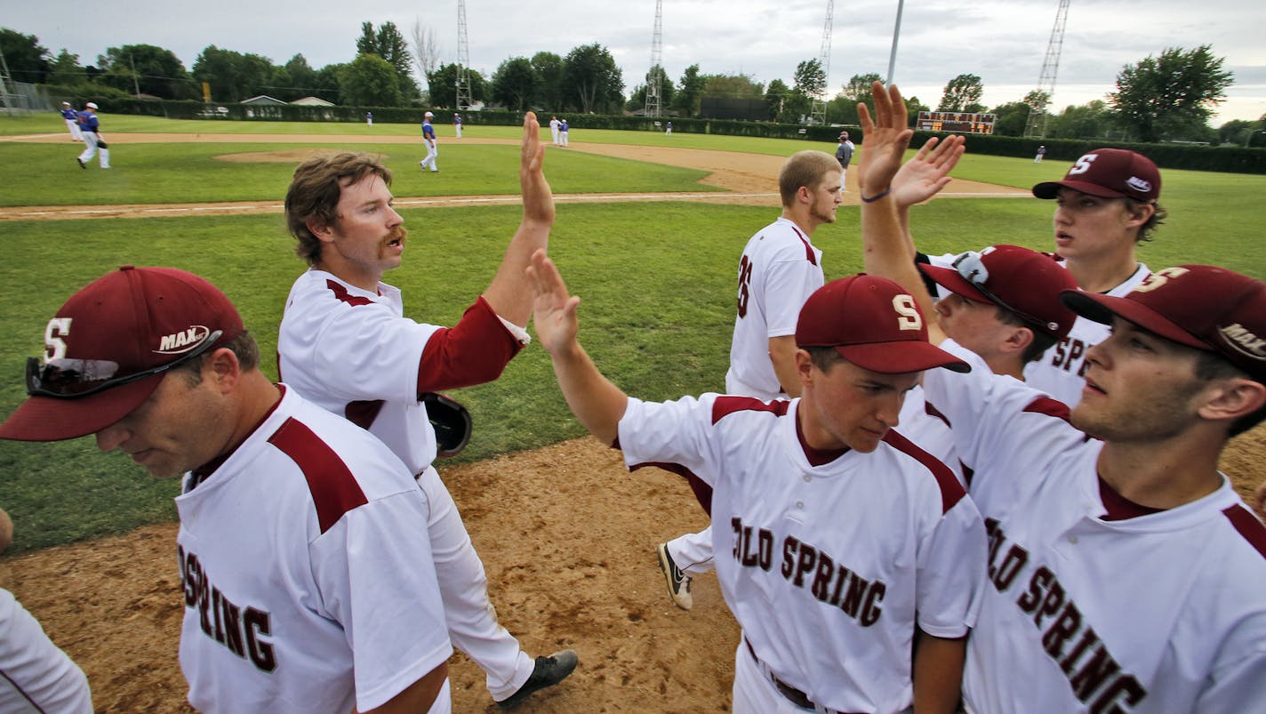 The Cold Spring Springers celebrate the scoring of a run in a game against the Lake Henry Lakers. ] A look at the Cold Spring Springers amateur baseball town team of Cold Spring. The teams have a tradition of family members playing and managing for many years with their children helping out as bat boys and grounds keepers. (MARLIN LEVISON/STARTRIBUNE(mlevison@startribune.com)