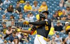 The Pirates' Oneil Cruz hits a two-run homer in the sixth inning against the Rockies on Sunday in Pittsburgh.
