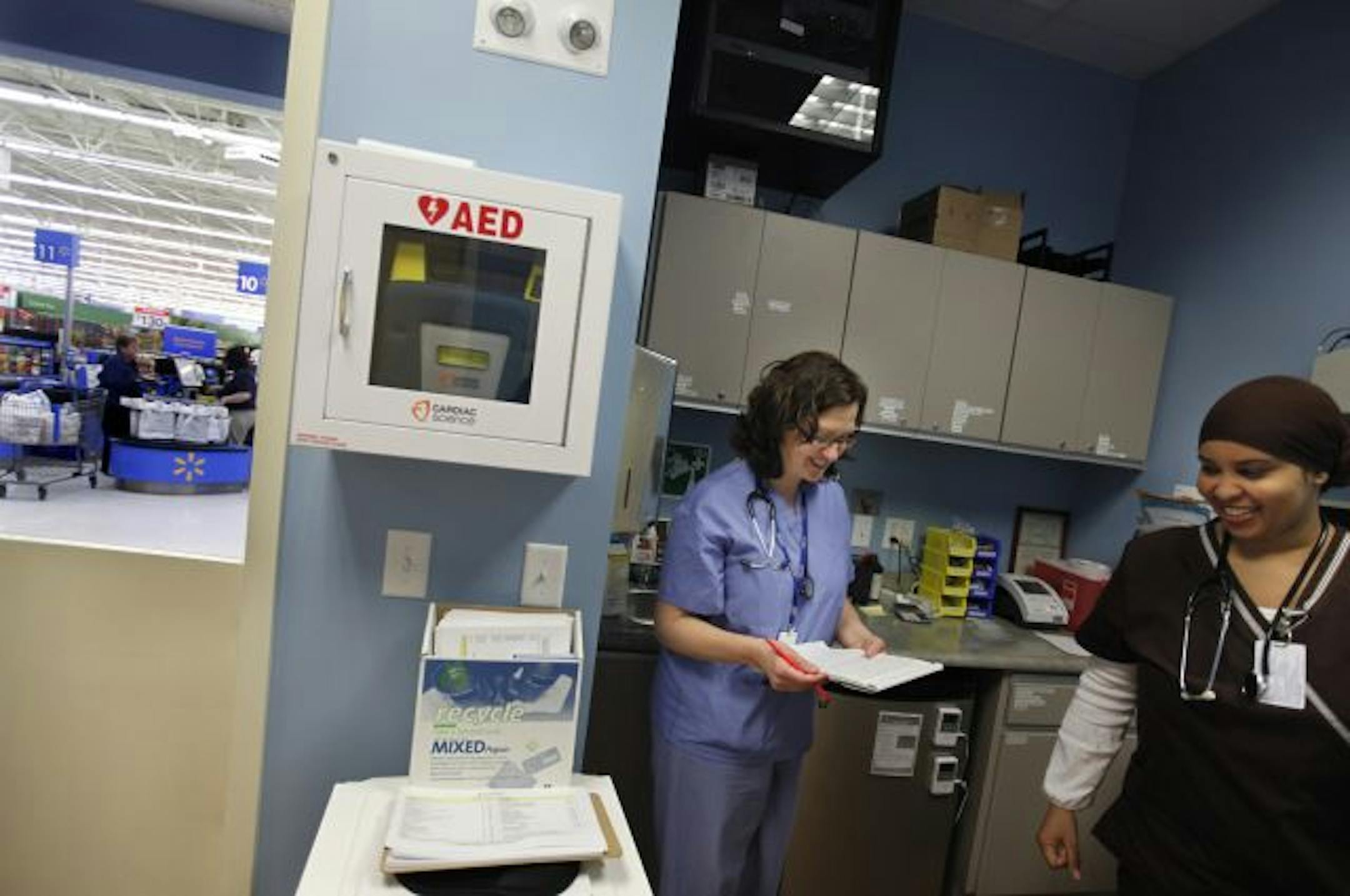 At the retail clinic opened by Hennepin County Medical Center at the Wal-Mart in Bloomington, physician assistant Brenda Baker helped to train medical assistant Kaltuma Ali. The clinic offers treatment for minor common illnesses such as flu symptoms.
