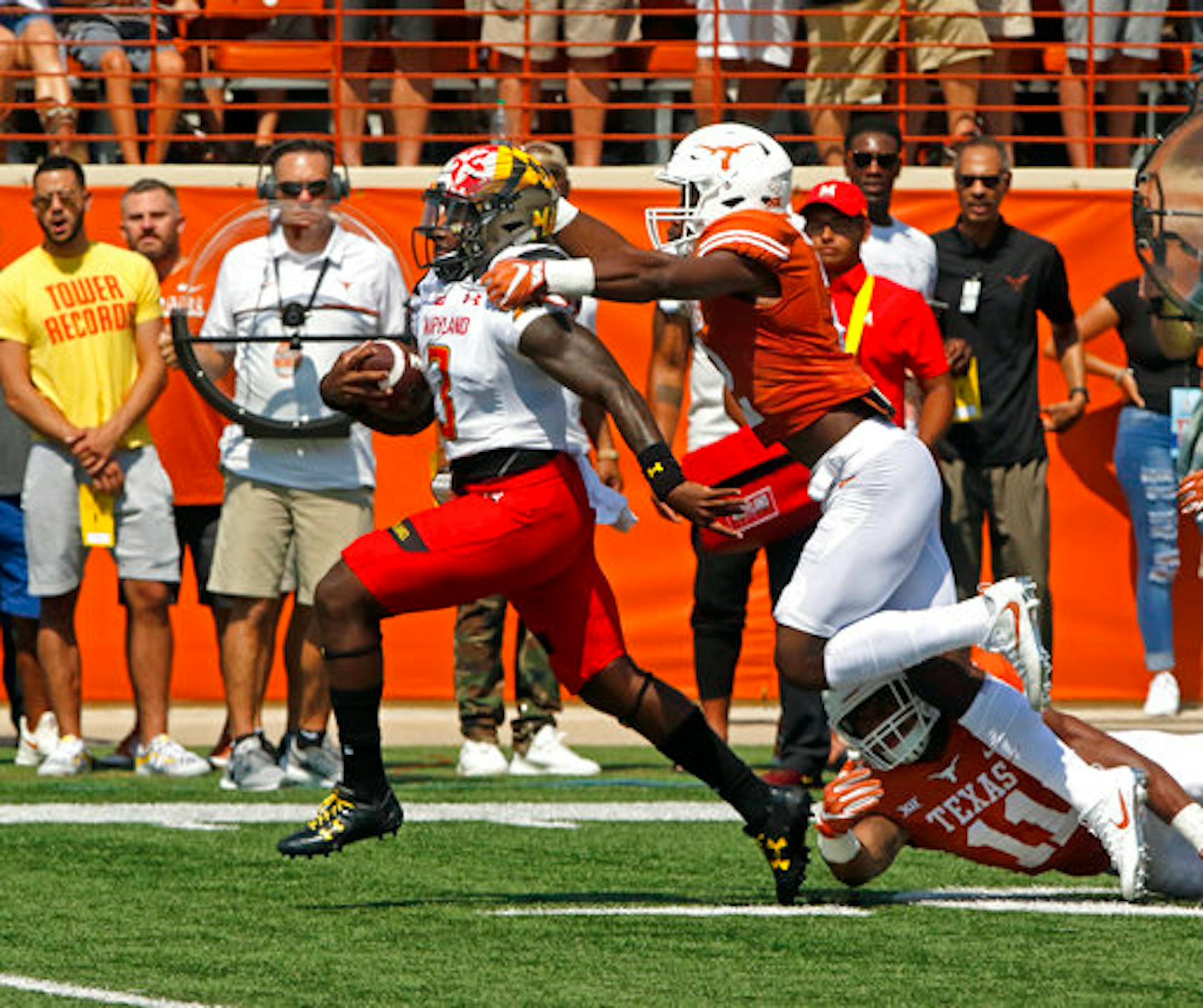 Maryland quarterback Tyrrell Pigrome, left, runs for a touchdown against Texas defensive back Kris Boyd, right, during the first half of an NCAA college football game, Saturday, Sept. 2, 2017, in Austin, Texas. (AP Photo/Michael Thomas)