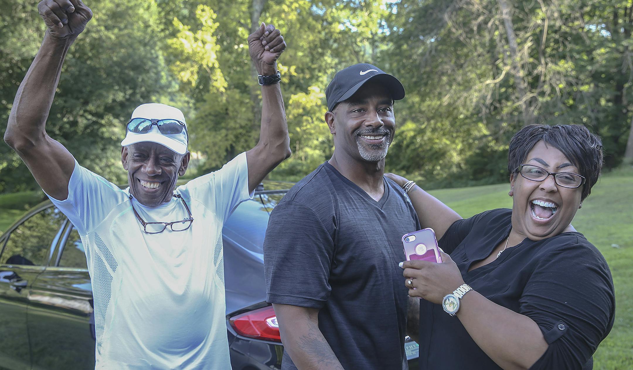 Chester Hollman III celebrates with his father Chester Hollman, Jr., left and his sister Deanna as he takes his first steps of freedom from the State Correctional Institution at Retreat in Hunlock Creek, Pennsylvania on Monday, July 15, 2019. Hollman was ordered release from prison after serving 28 years of a life sentence for a murder for which he was innocent. The Commonwealth is expected to formally drop all charges against him later this month.