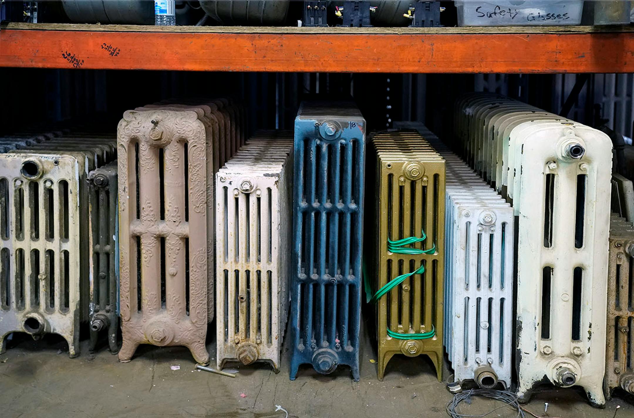 Radiators of all sizes and styles are lined up in a row.