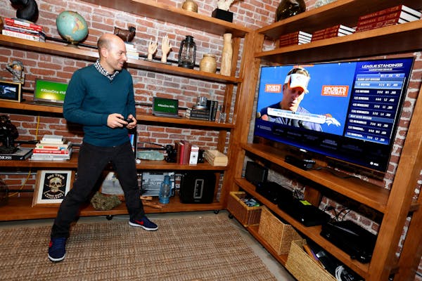 IMAGE DISTRIBUTED FOR XBOX - Paul Scheer of The League uses The NFL on Xbox One to check his fantasy team, on Sun., Nov. 17, 2013 in Venice Beach, Cal