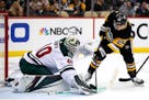Minnesota Wild goaltender Devan Dubnyk (40) blocks a shot by Pittsburgh Penguins' Dominik Kahun (24) during the second period of an NHL hockey game in