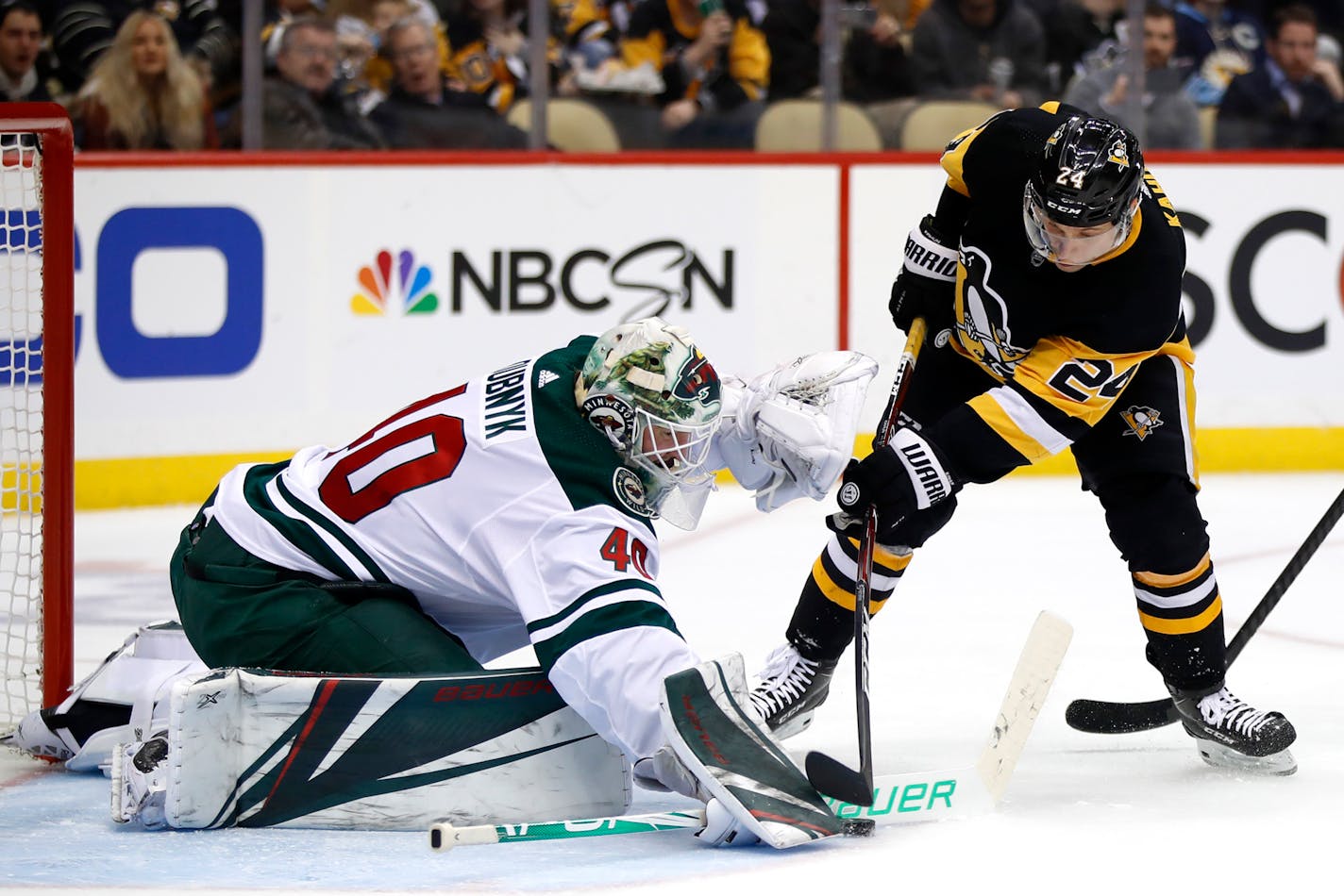 Minnesota Wild goaltender Devan Dubnyk (40) blocks a shot by Pittsburgh Penguins' Dominik Kahun (24) during the second period of an NHL hockey game in Pittsburgh, Tuesday, Jan. 14, 2020. (AP Photo/Gene J. Puskar)