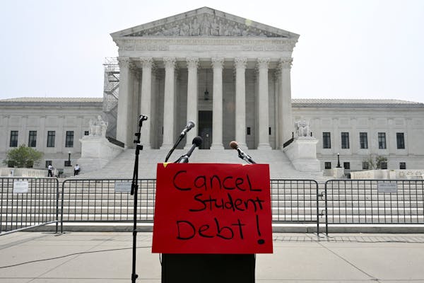 A “cancel student debt” poster on a lectern before demonstrators spoke outside the Supreme Court in Washington, June 30, 2023. 