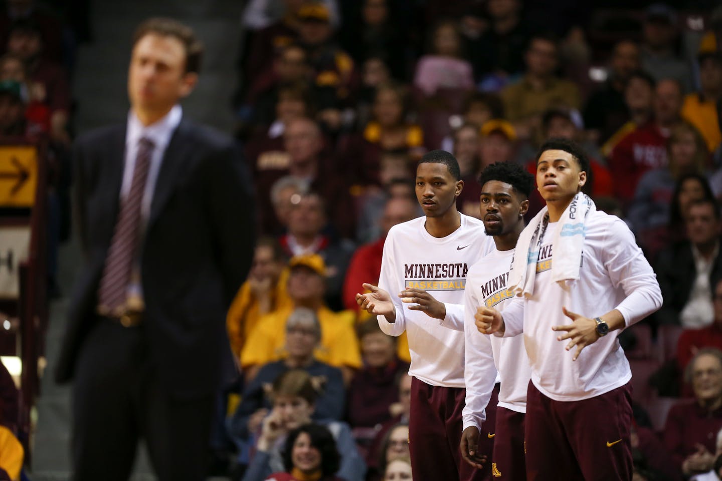 Suspended Gophers guards Dupree McBrayer, Kevin Dorsey, and Nate Mason stood on the edge of the court while teammates played against Wisconsin on Wednesday night.