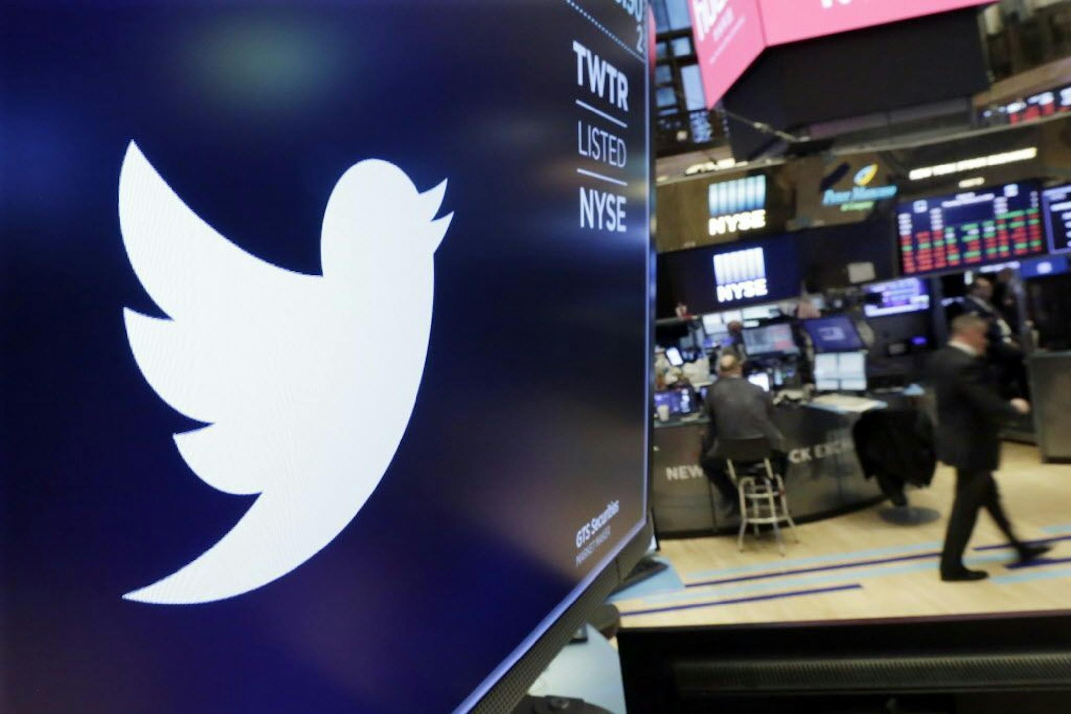 FILE - In this Feb. 8, 2018 file photo, the logo for Twitter is displayed above a trading post on the floor of the New York Stock Exchange. Twitter Inc., on Friday, July 27 reported second-quarter net income of $100.1 million, after reporting a loss in the same period a year earlier. On a per-share basis, the San Francisco-based company said it had net income of 13 cents. Earnings, adjusted for one-time gains and costs, were 17 cents per share.