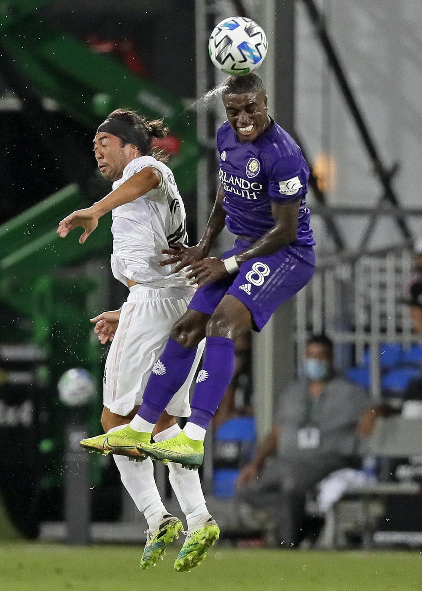 Orlando City's Jhegson Mendez (8) heads the ball next to Inter Miami's Lee Nguyen during the second half of an MLS soccer match, Wednesday, July 8, 2020, in Kissimmee, Fla. (AP Photo/John Raoux)