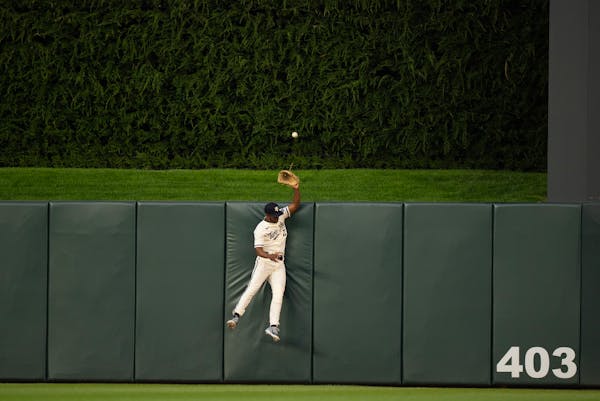 Minnesota Twins center fielder Michael A. Taylor (2) jumps in vain to try to rob San Diego Padres left fielder Juan Soto (22) of a home run in the sev