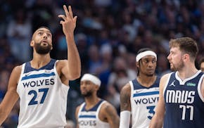 Rudy Gobert of the Timberwolves gestures while Luka Doncic looks on during Game 3 of the Western Conference finals in Dallas.
