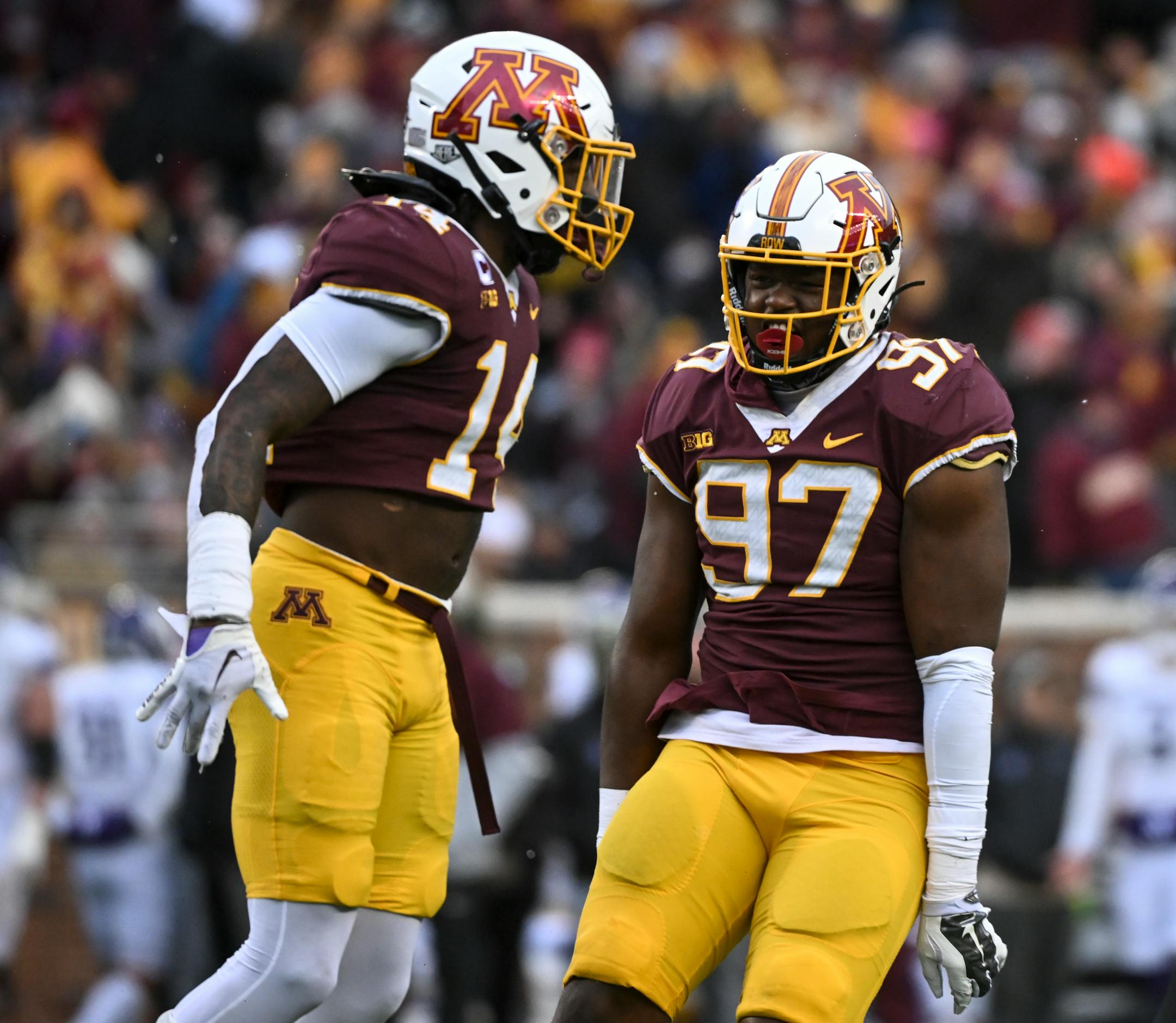 Minnesota Gophers defensive lineman Jalen Logan-Redding (97) celebrate a sack by linebacker Braelen Oliver (14) against the Northwestern Wildcats during the first half.
