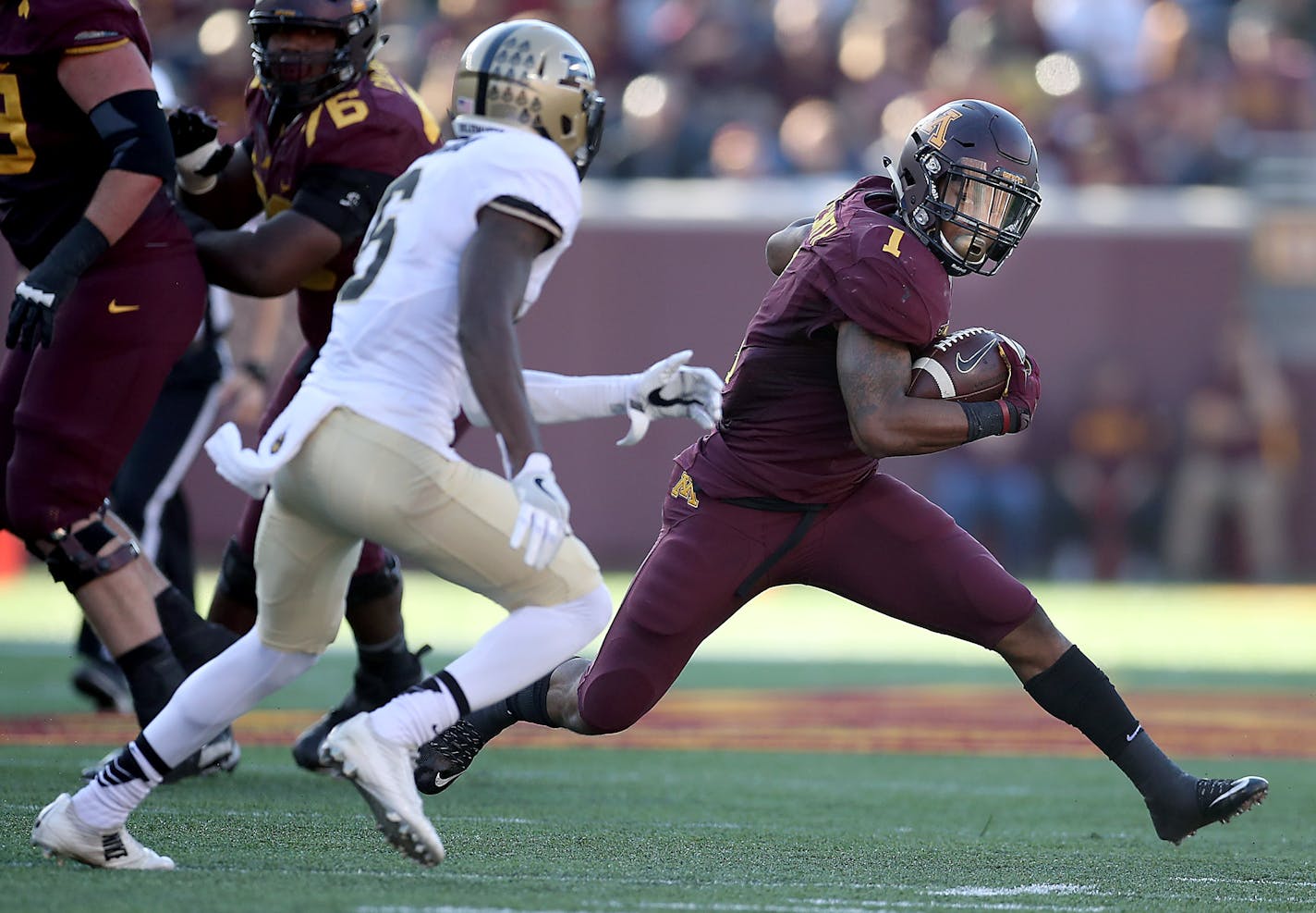 Minnesota's running back Rodney Smith ran by Purdue cornerback Myles Norwood for a first down during the second quarter Saturday.