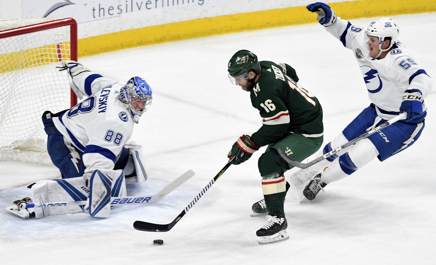 Minnesota Wild's Jason Zucker (16) moves in against Tampa Bay Lightning goal Andrei Vasilevskiy (88), of Russia, as the Lightning's Jake Dotchin, right, trails the play in the first period of an NHL hockey game Saturday, Jan. 20, 2018, in St. Paul, Minn.