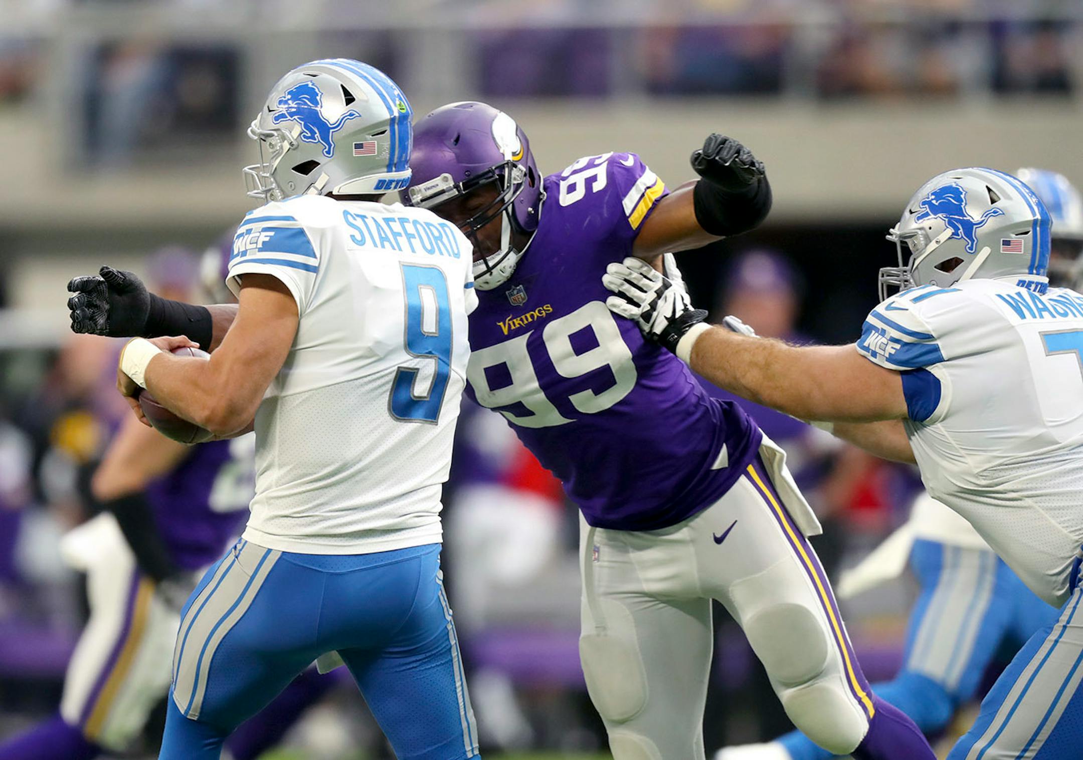 Detroit Lions quarterback Matthew Stafford (9) was sacked by Minnesota Vikings defensive end Danielle Hunter (99) for a five yard loss on the first play of the game.