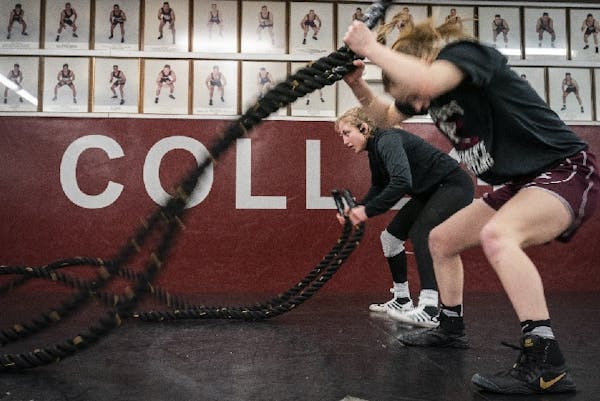Augsburg wrestlers Emily Shilson (right, working out with teammate Gabby Skidmore in January) won two national titles over the weekend in Omaha.