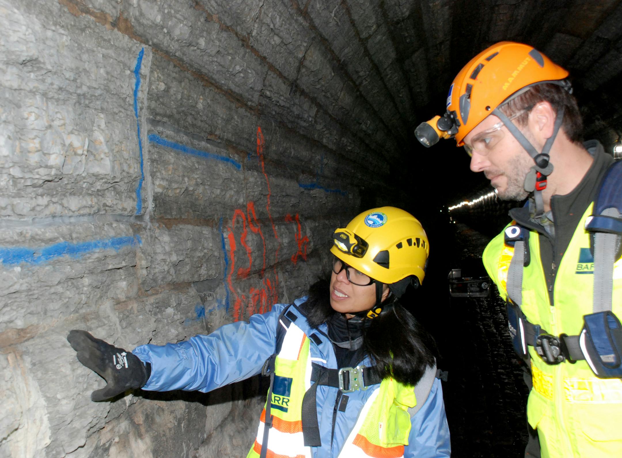 Workers inspect repairs.