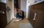 Michelle Doran checked in on her roach traps as she babysat 16-month-old Maddielynn, cq, in her 1960s' era apartment complex, Wednesday, January 29, 2