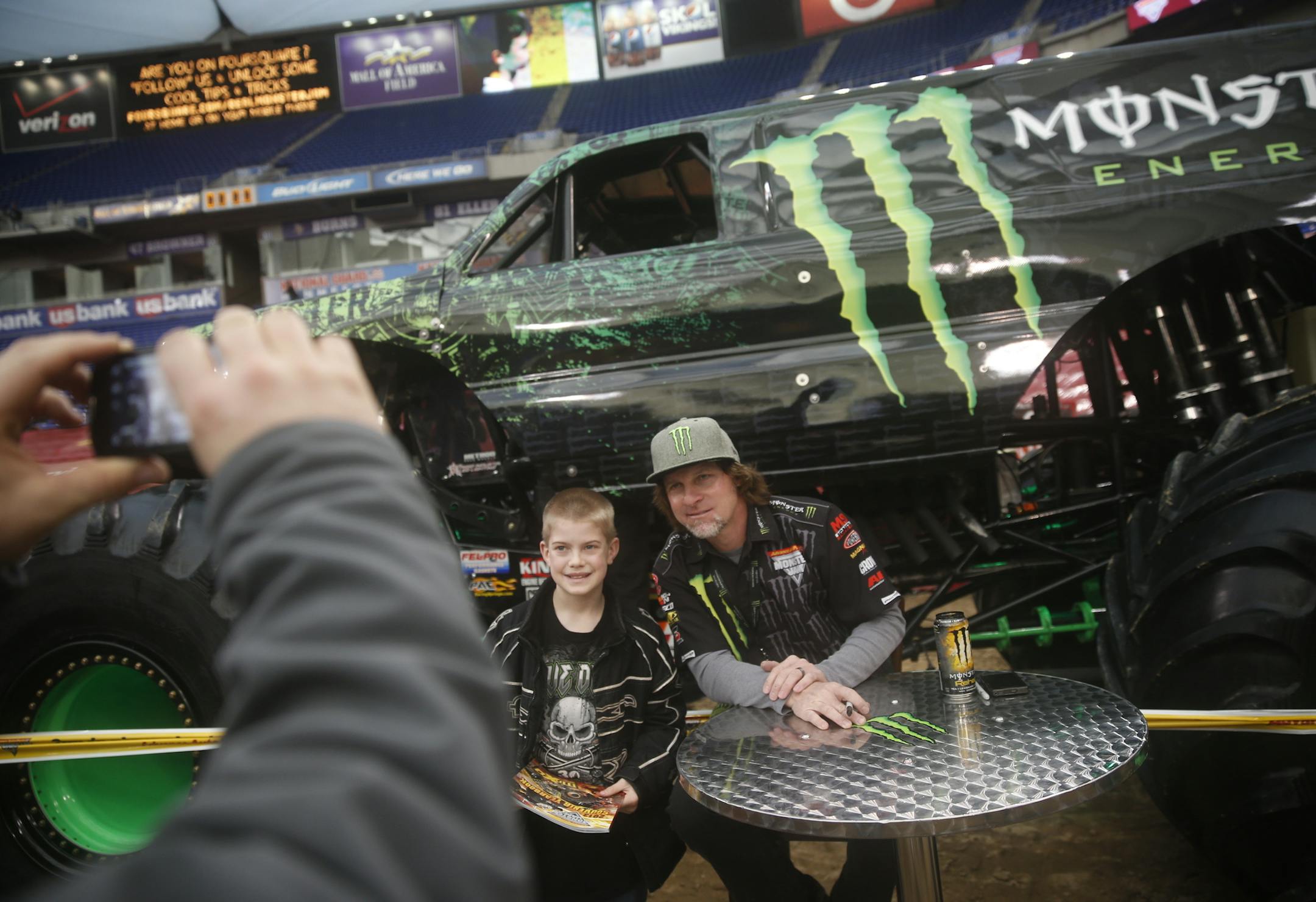 At the Metrodome where the last monster truck rally is being held before the building is demolished, Tyler Peters,10, of Sauk Centre, had his picture taken with driver Damon Bradshaw in front of the Monster Energy monster truck which has 1500 HP. ]richard tsong-taatarii/rtsong-taatarii@startribune.com