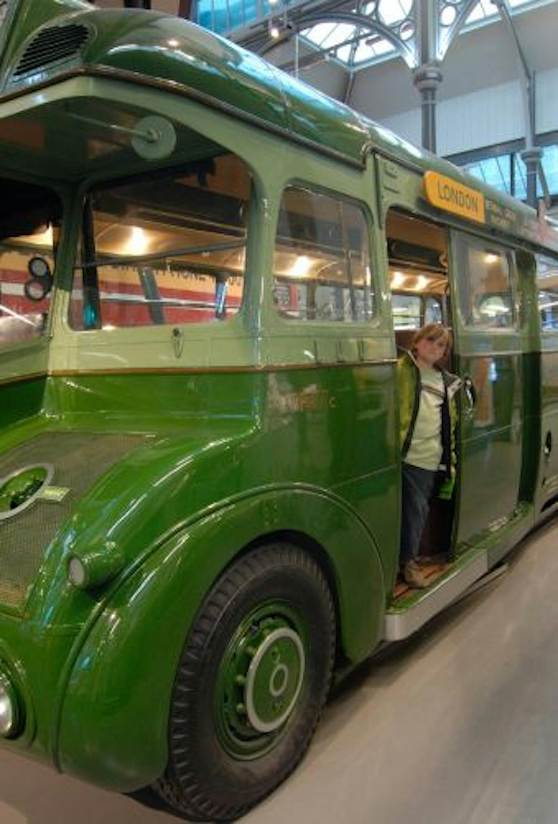 Julian steps off a vintage bus at the London Transport Museum.