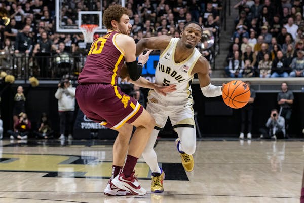 Gophers forward Jamison Battle defended guard Brandon Newman during Sunday’s loss at Purdue.