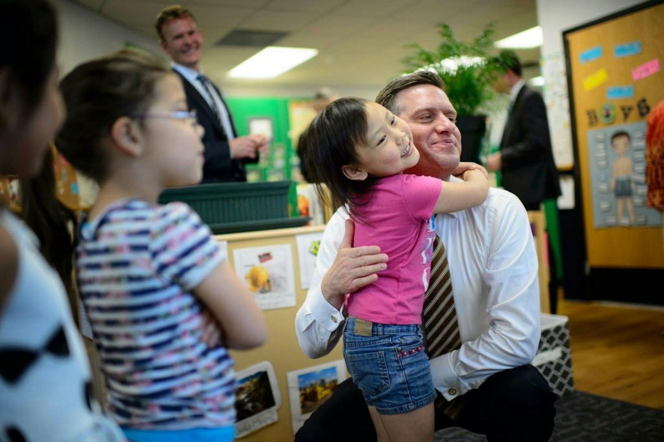 Gavin Vang, 5, wanted to give House Speaker Kurt Daudt a hug before he left New Horizon, and other students lined up to be next.