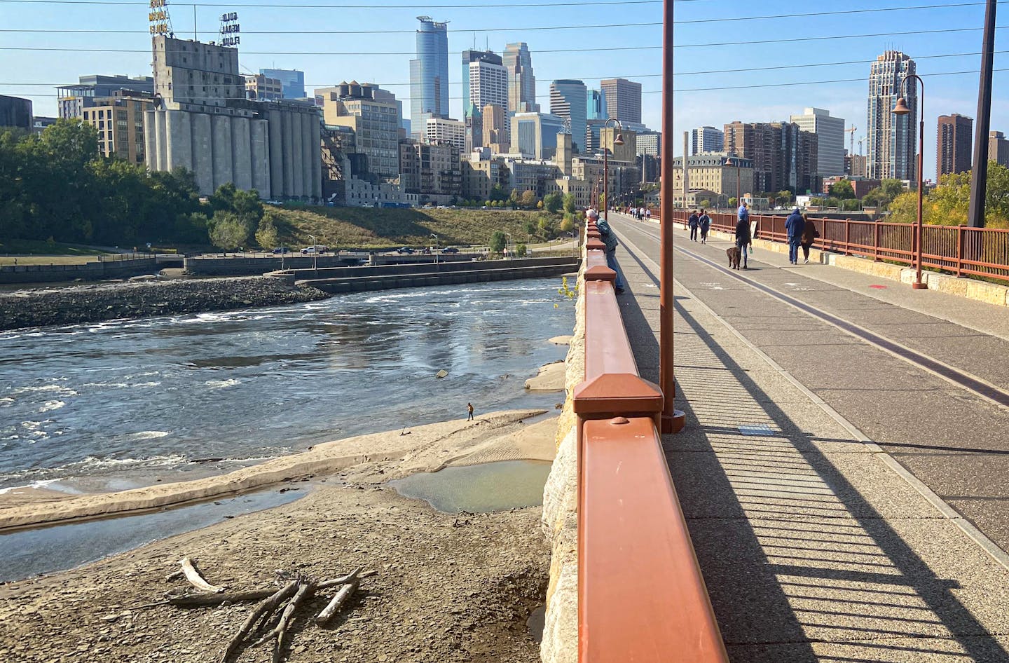 People wandered the Mississippi River bottom Monday afternoon below the Stone Arch Bridge as the Army Corps of Engineers lowered the river to allow inspection of the upper and lower lock and dams.