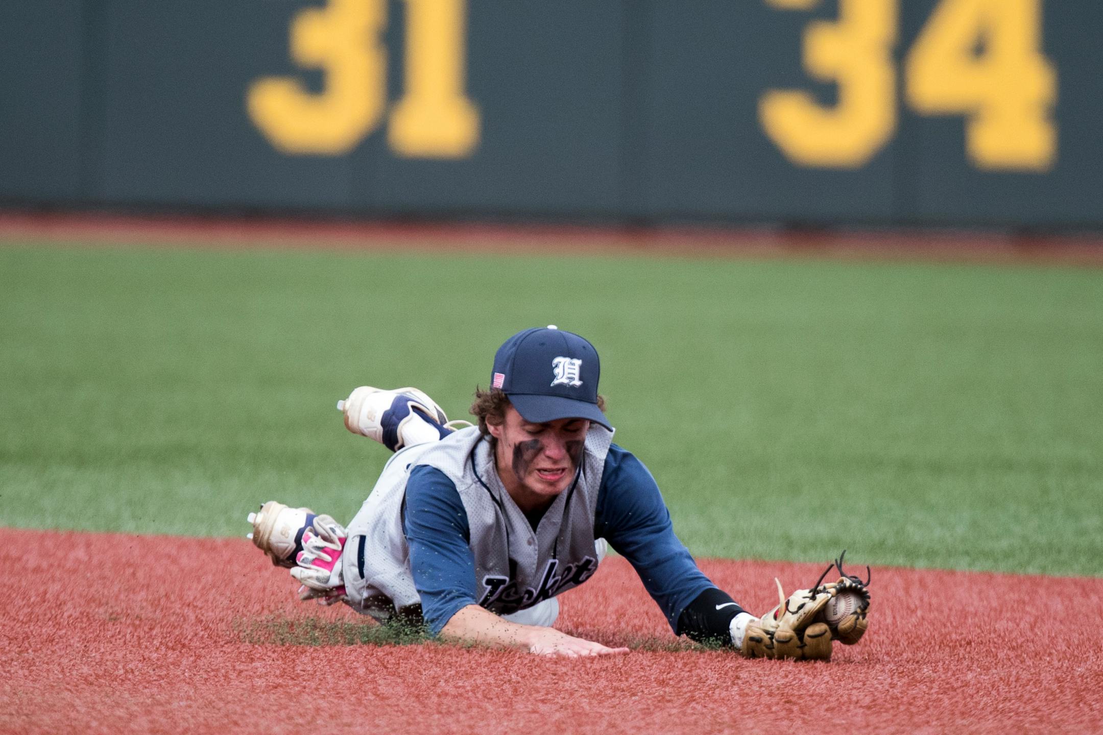Riley Versich hit the turf to make a putout for Hibbing, which has lost in three previous Class 3A title-game appearances.