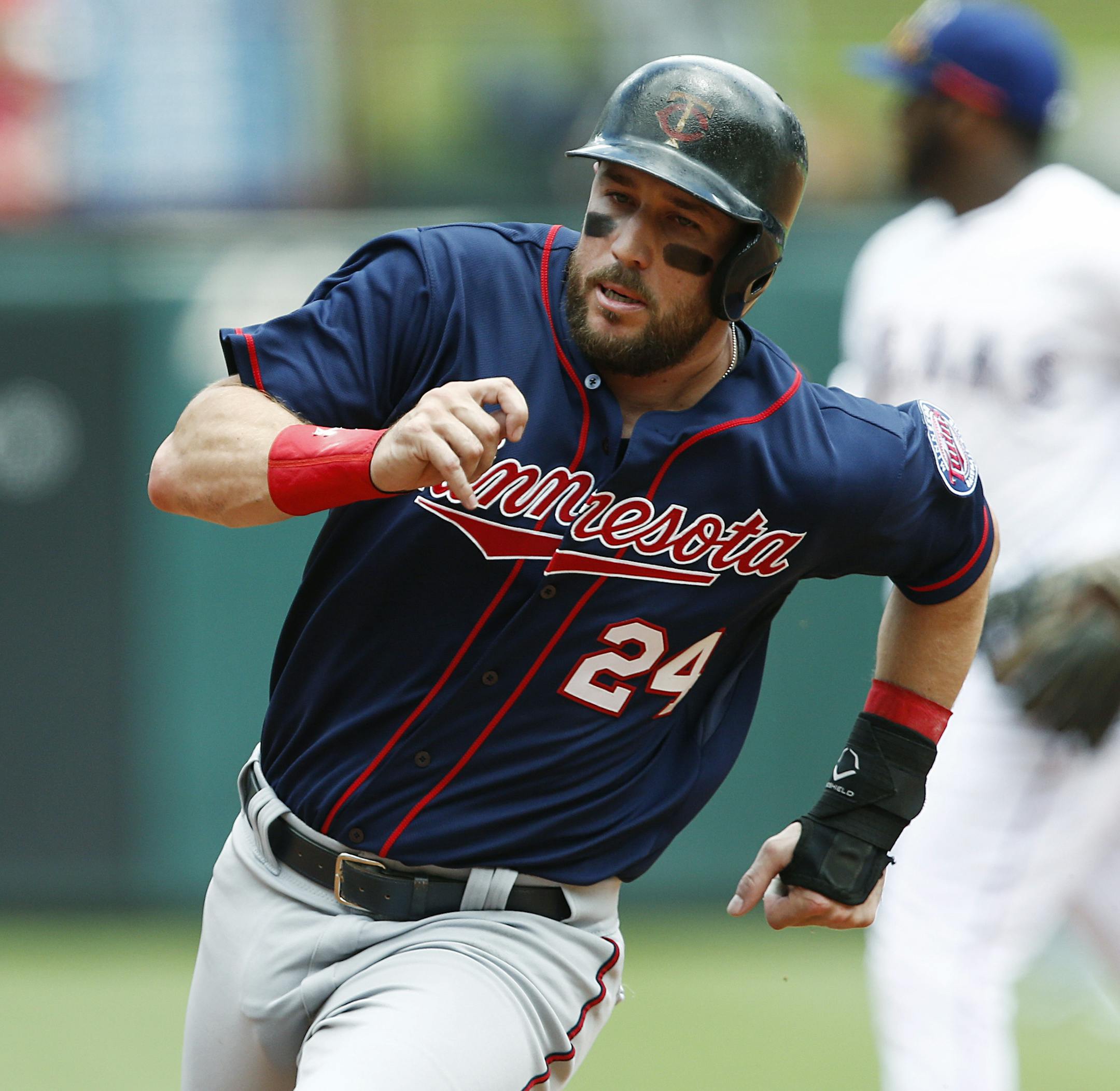 Minnesota Twins' Trevor Plouffe heads around second on his way to score on a double by Eduardo Nunez against the Texas Rangers during the first inning of a baseball game, Sunday, June 14, 2015, in Arlington, Texas. (AP Photo/Jim Cowsert)