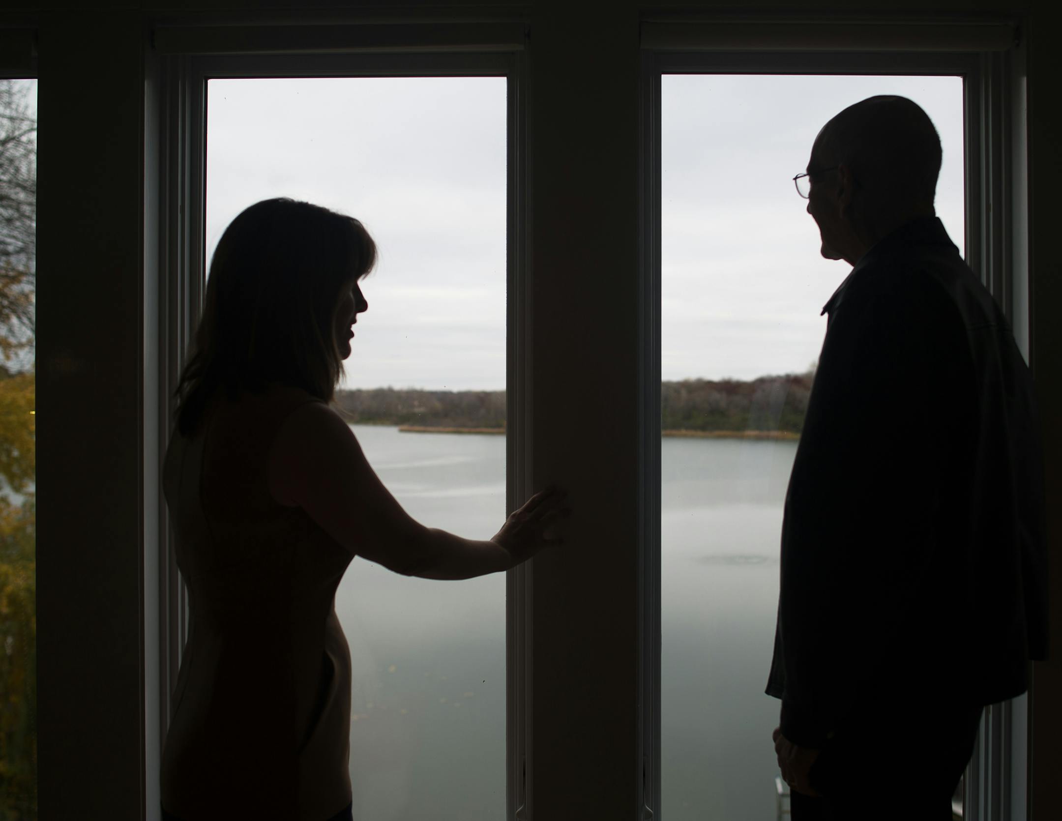 Golden Valley residents Jane McDonald Black (CQ) and Dave Hanson (cq) look out onto Sweeney Lake from Black's living room in a portrait Wednesday afternoon. ] AARON LAVINSKY • aaron.lavinsky@startribune.com Jane McDonald Black (cq) and Dave Hanson (cq) are some of the Golden Valley residents working to save Sweeney Lake from degradation caused by nearby development. The lake was crystal clear before the construction of the I-394 and widening of Olson Memorial Highway caused salt and sedim