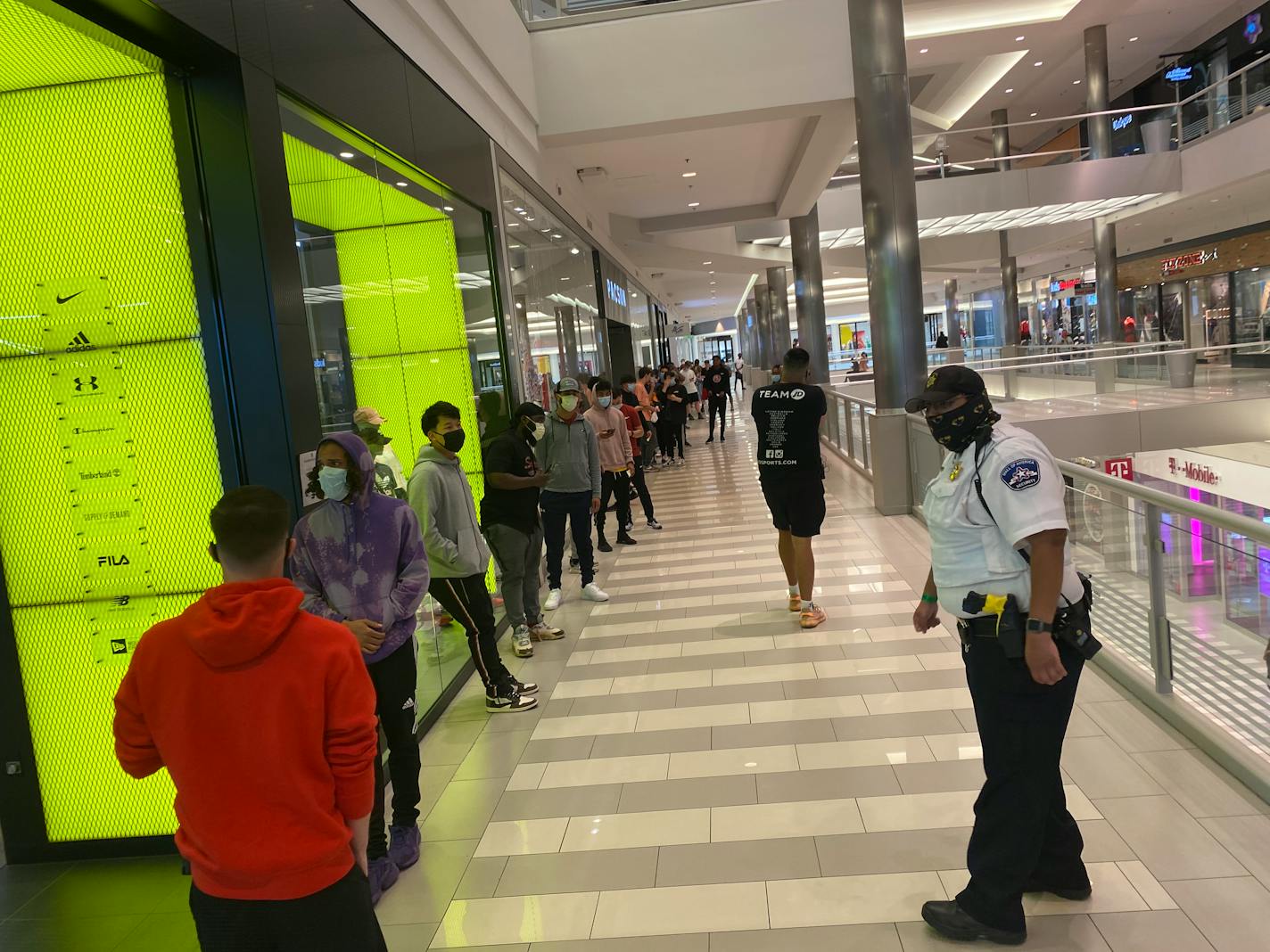 Customers lined up Wednesday outside the JD athletic shoe store at the Mall of America, which reopened Wednesday for the first time since closing in March.