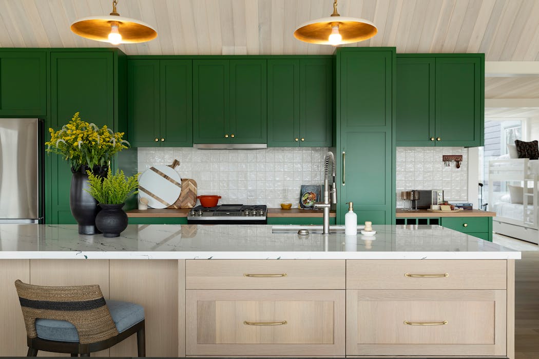The kitchen of a Luck, Wis., lakeside retreat is dressed in Arugula Green by Martha O’Hara Interiors. 