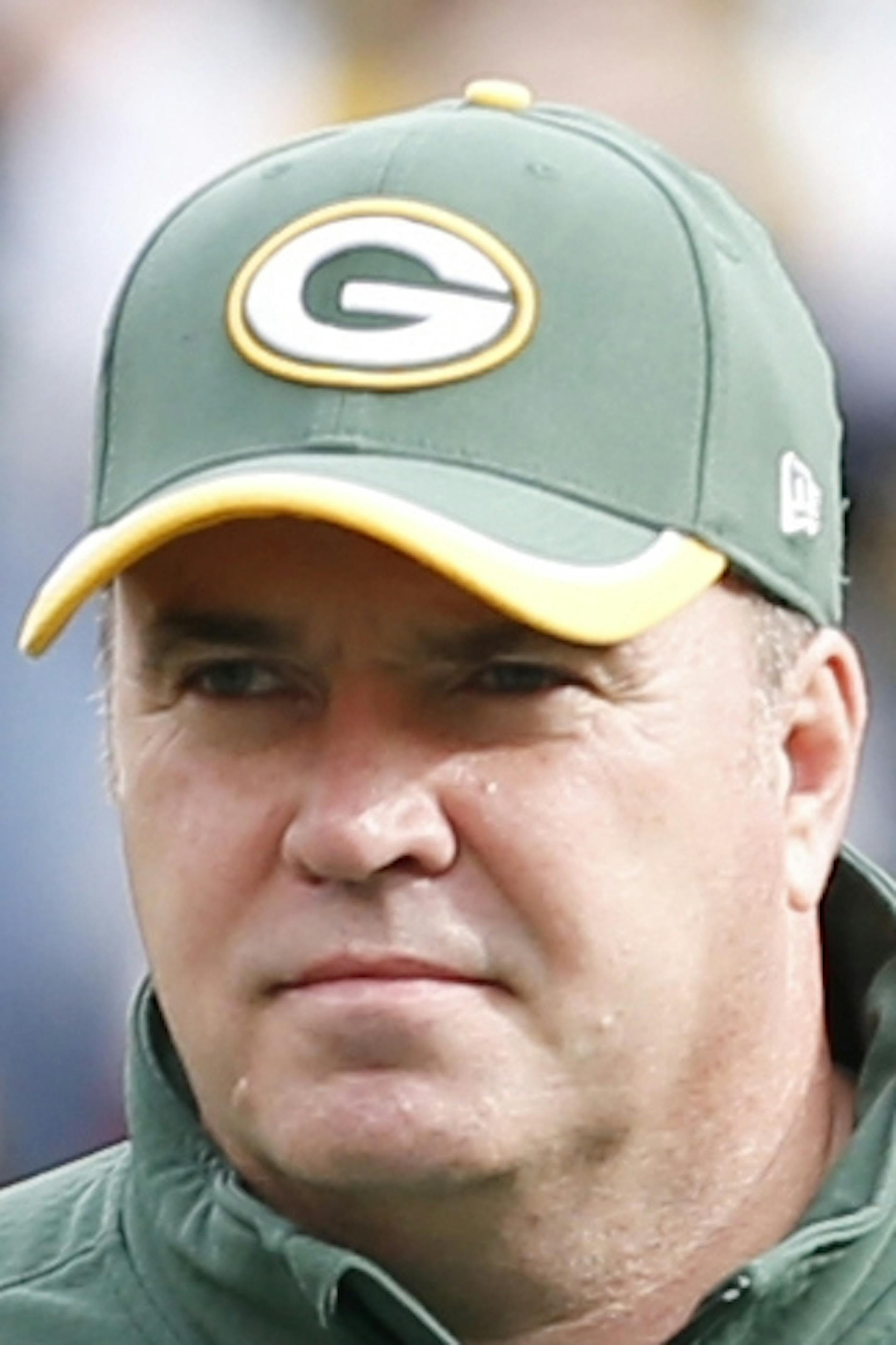 Carolina Panthers head coach Ron Rivera talks to Green Bay Packers head coach Mike McCarthy, right, before an NFL football game Sunday, Oct. 19, 2014, in Green Bay, Wis. (AP Photo/Mike Roemer)
